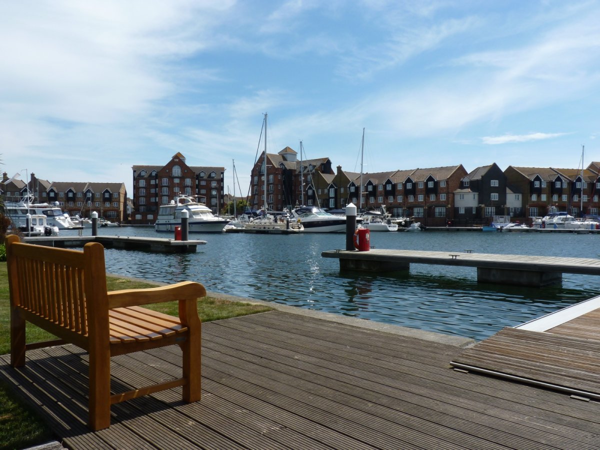 Bench in lower garden with view over private jetty and marina